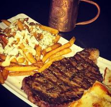 Greek-style Rib Eye and fries at Jimmy D's District Restaurant Arlington Heights